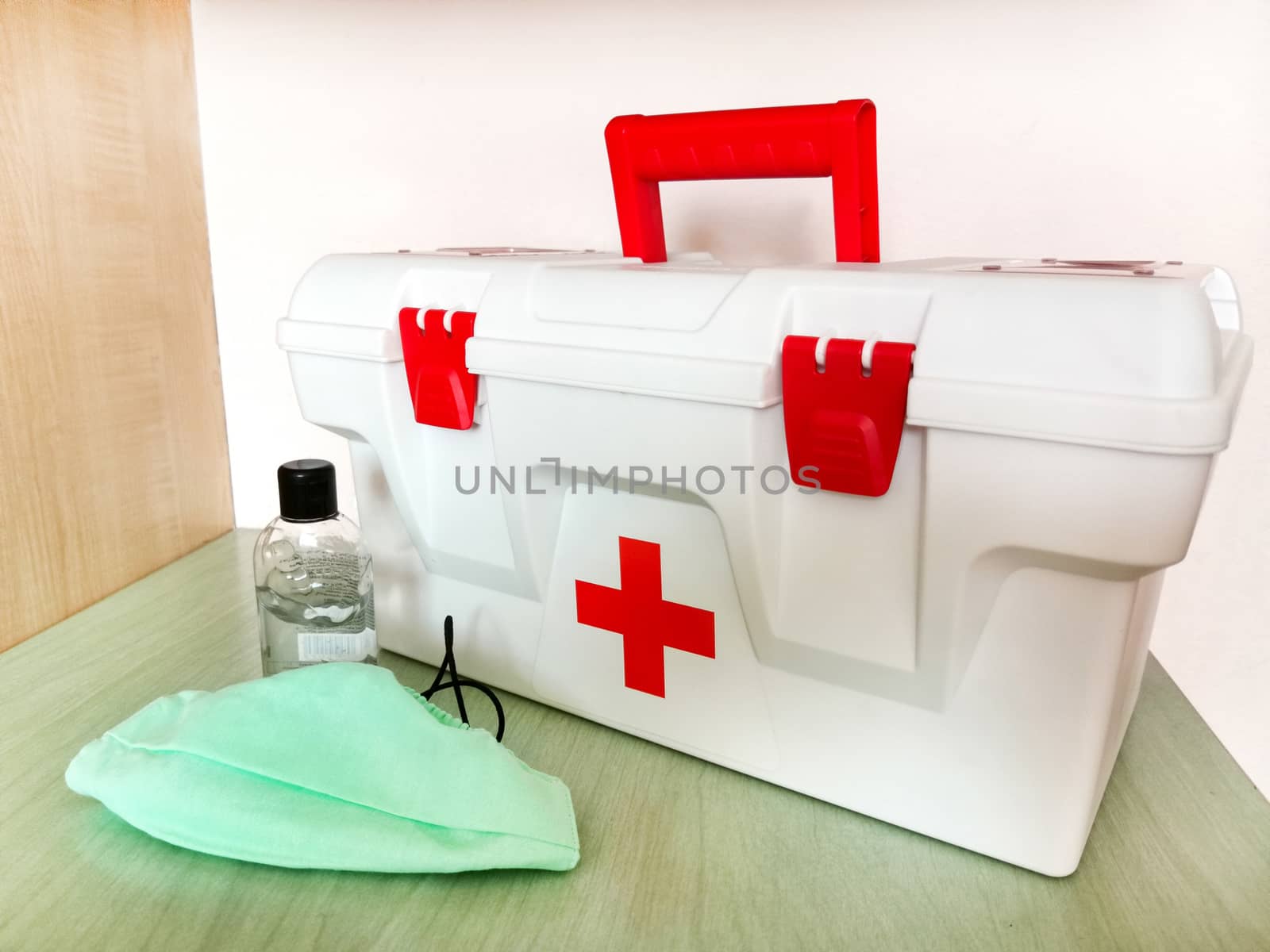 Home first aid kit with a respiratory face mask and disinfectant.Texture or background