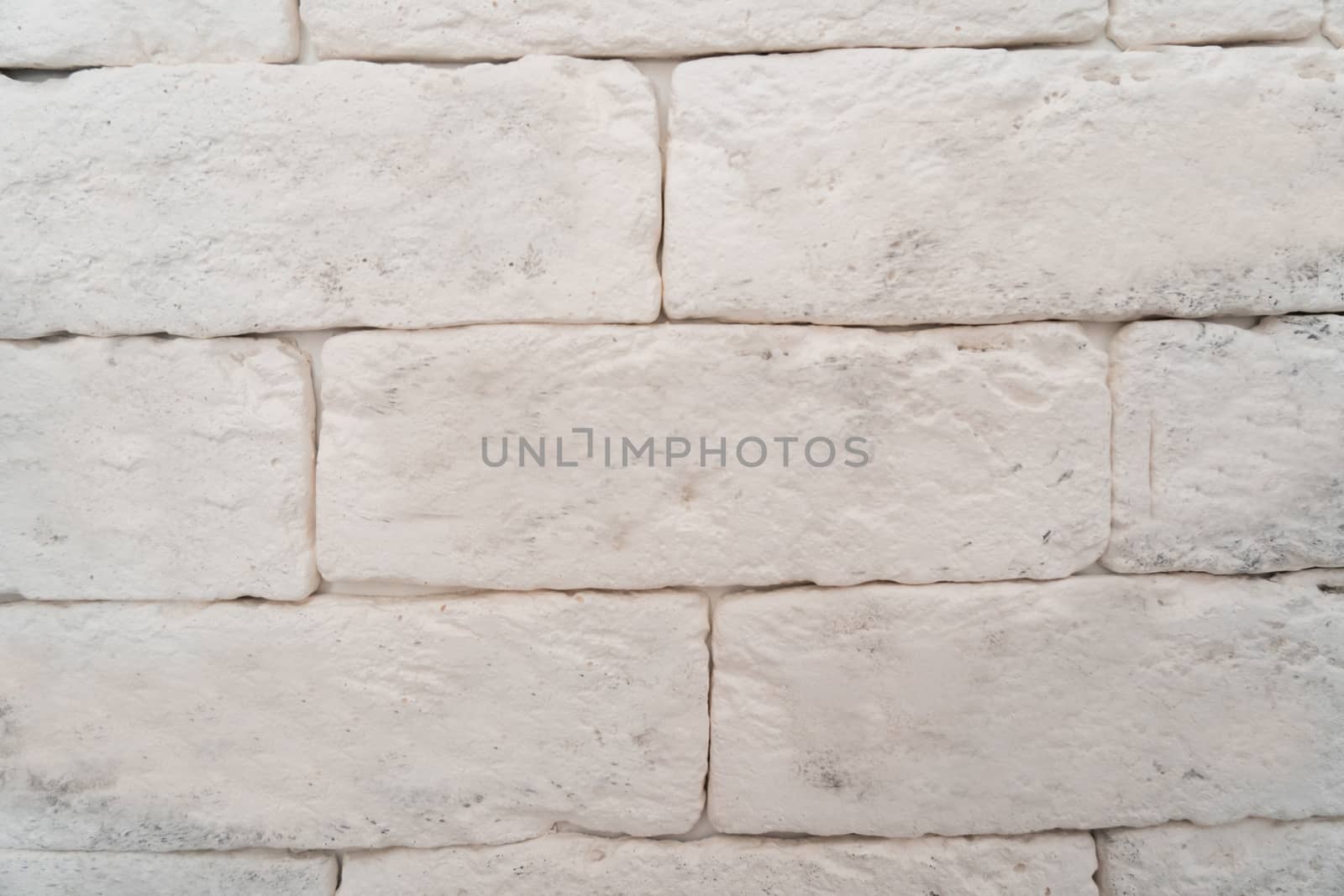The wall is made of white rectangular blocks