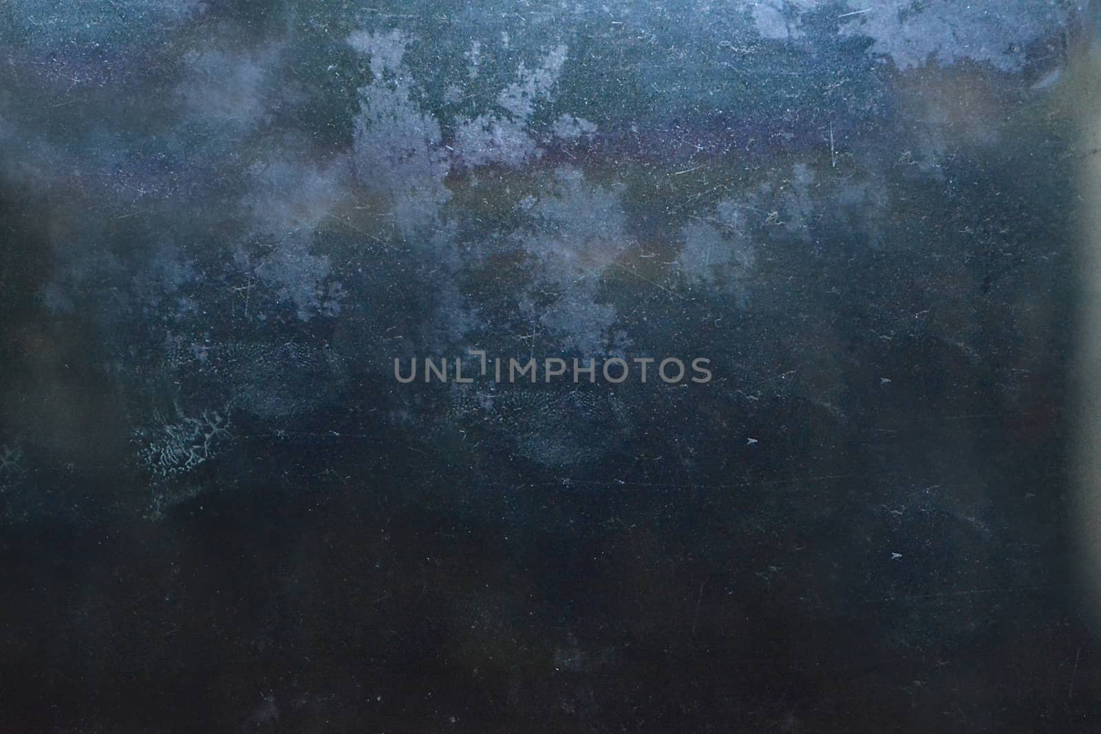 Dark blue background with scratches and lint on the surface