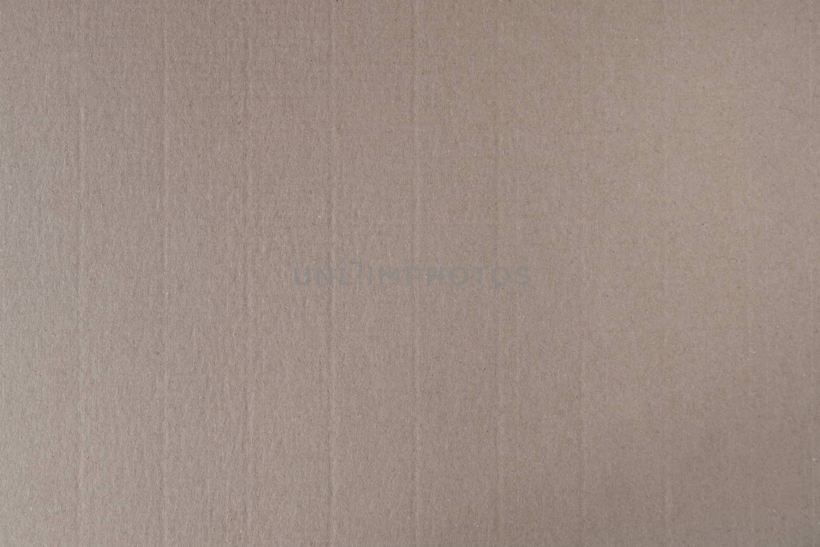 Pressed brown cardboard with a texture on the surface