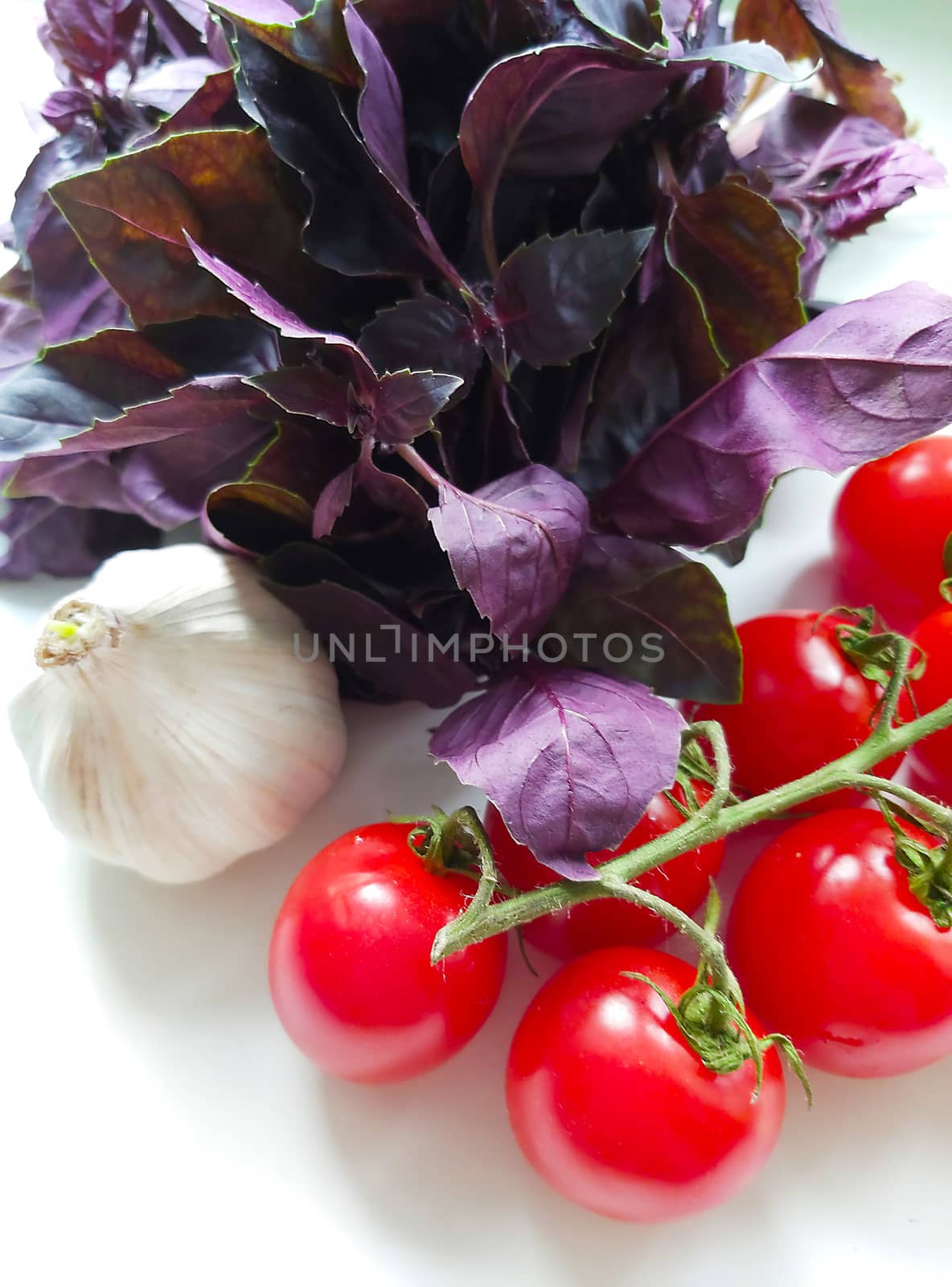 A sprig of cherry tomatoes with garlic and seasoning.Texture or background