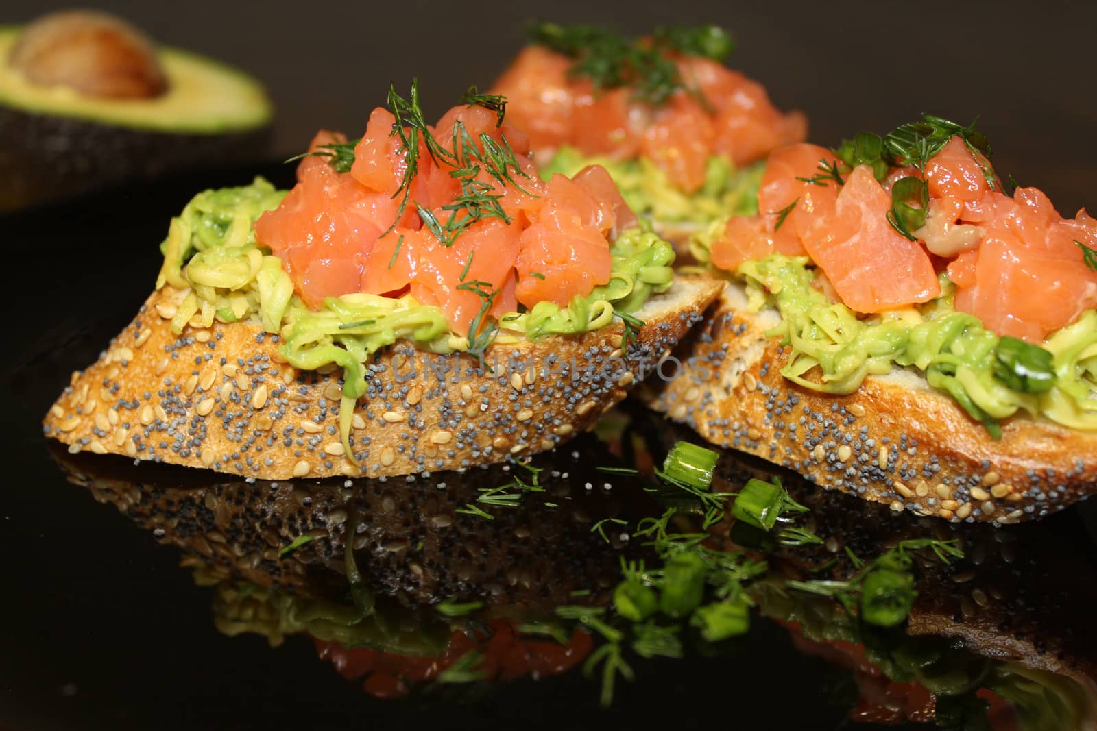 French loaf bruschetta with salmon and herbs. Snacks and sandwiches.