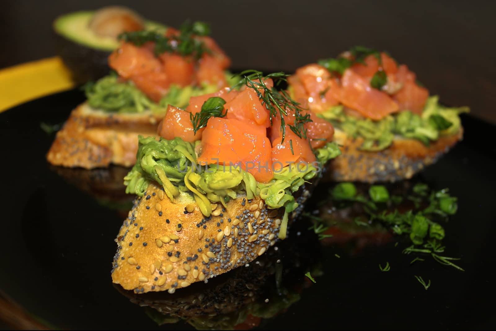 Sliced baguette with salmon and avocado slices