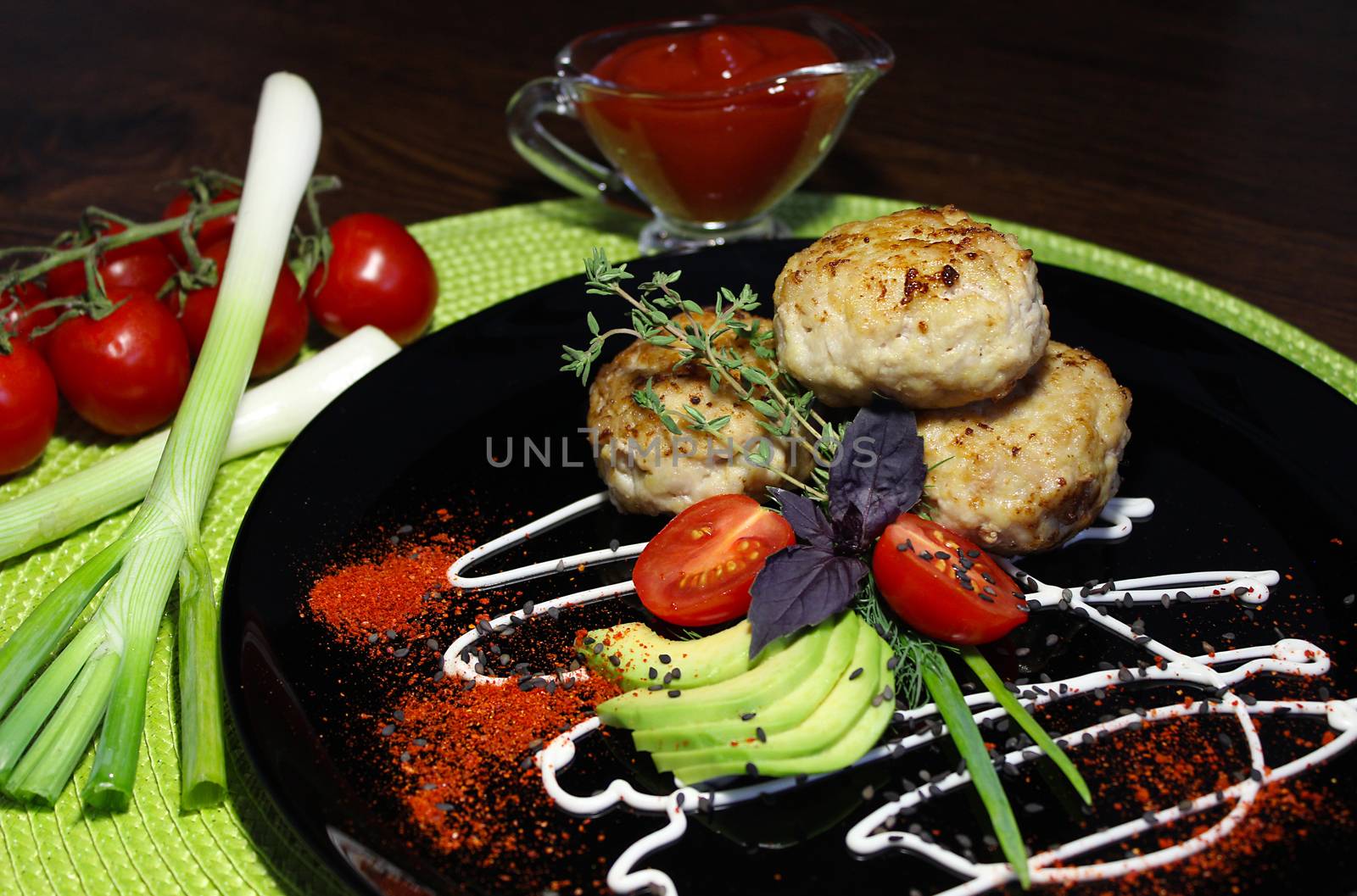 A dish of cutlets with seasoning and herbs with sliced zucchini