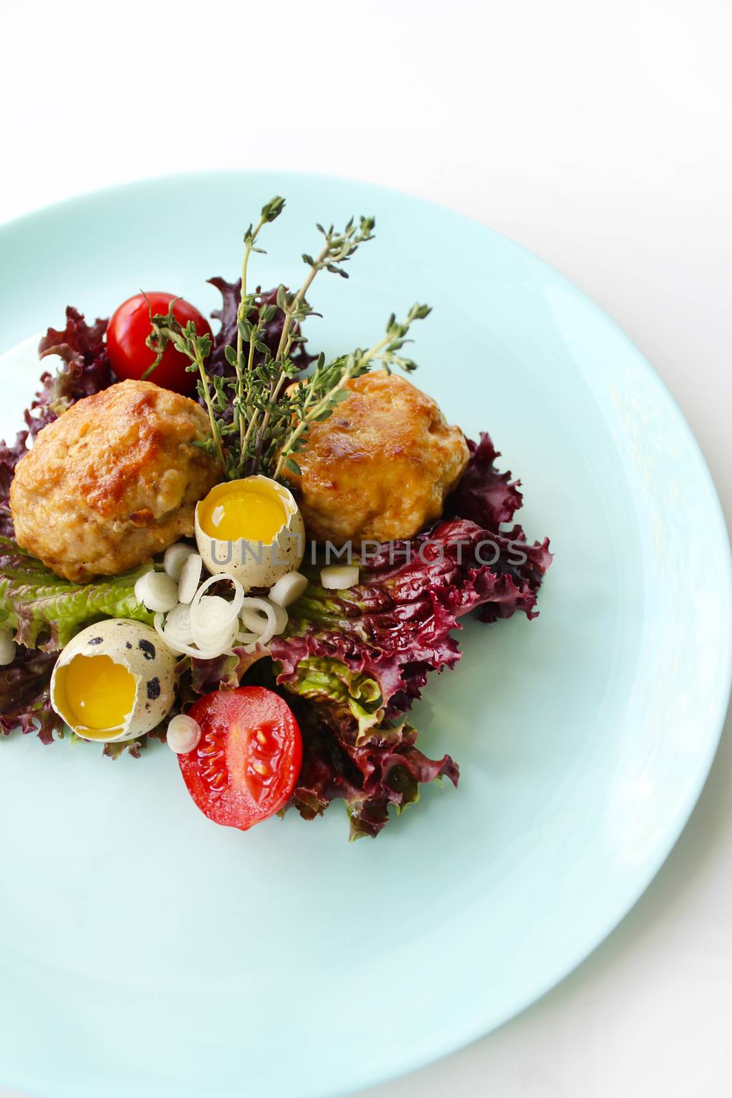 A beautifully designed dish of quail eggs and fried cutlets.Texture or background