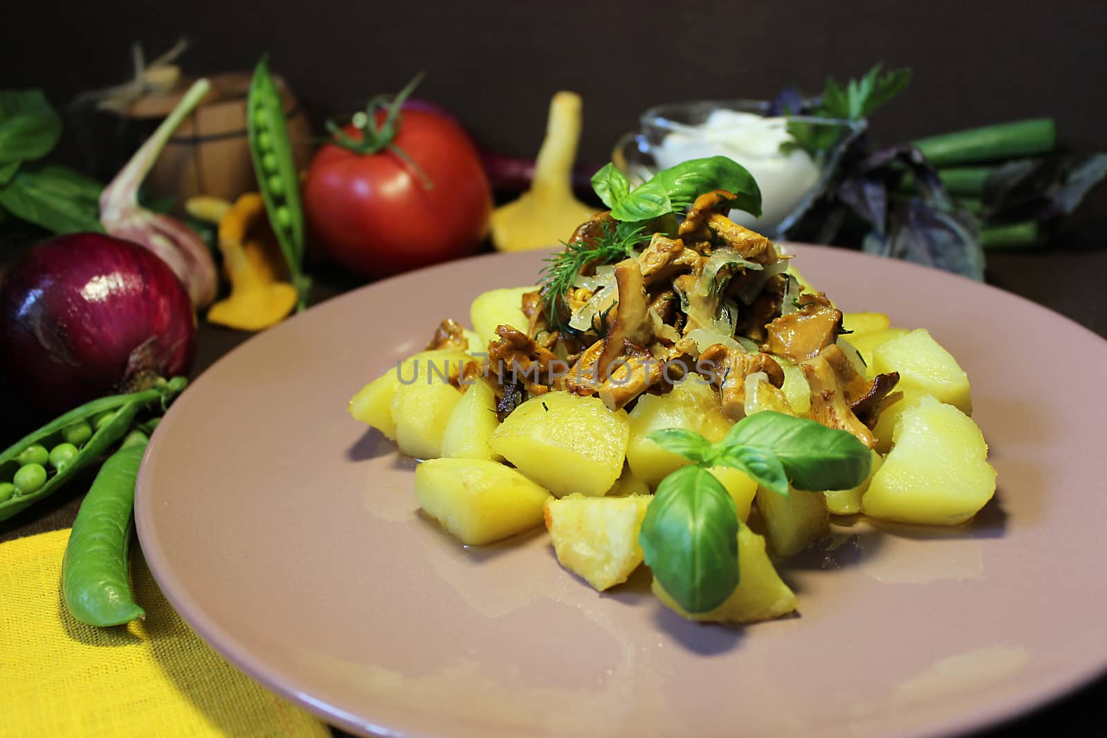 Hot dishes on the table with fried potatoes and mushrooms with herbs