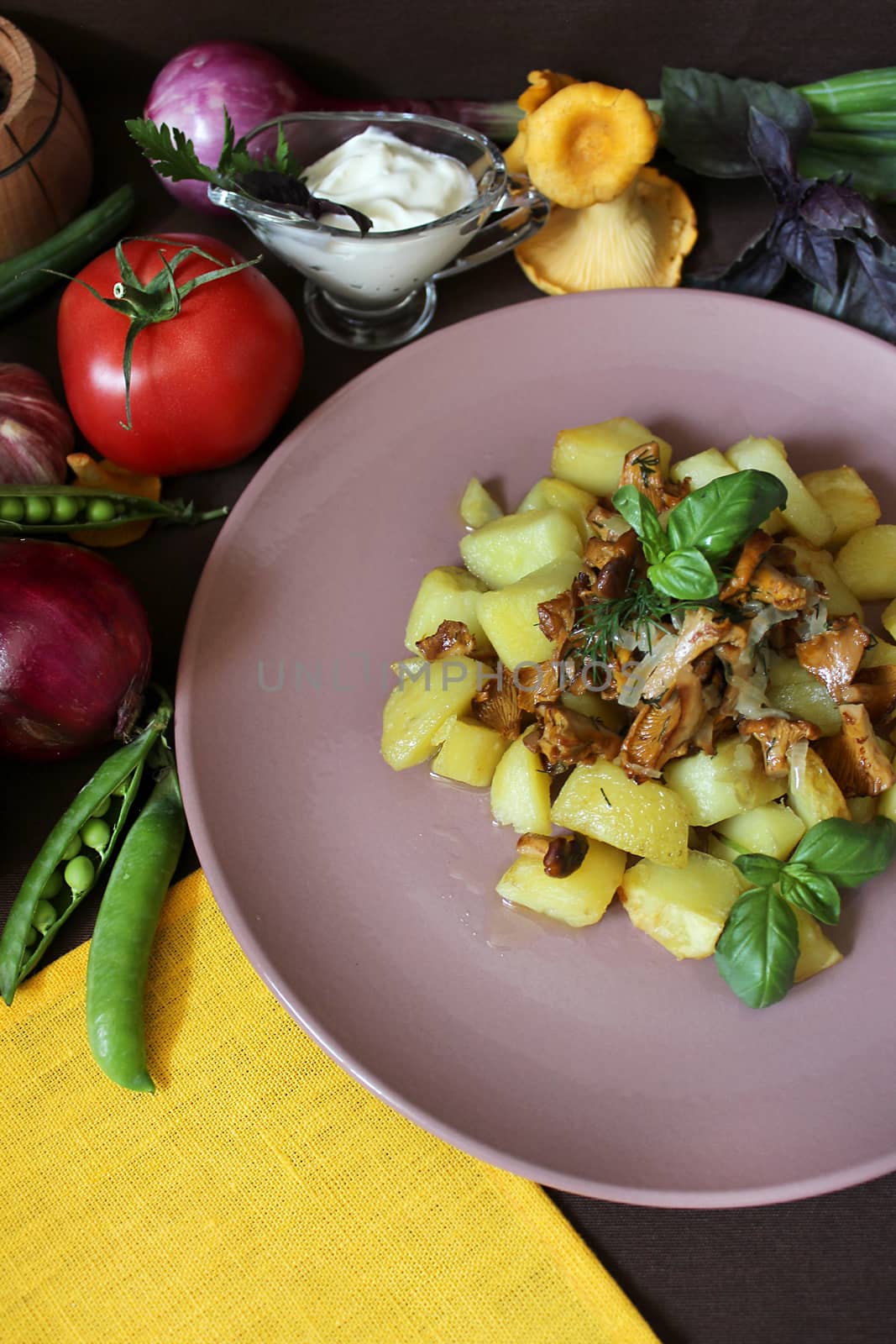 Prepared rustic dish with fried potatoes and mushrooms with herbs