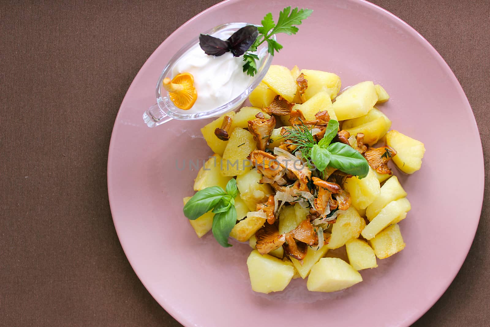 Country food fried potatoes with chanterelles and greens.Texture or background