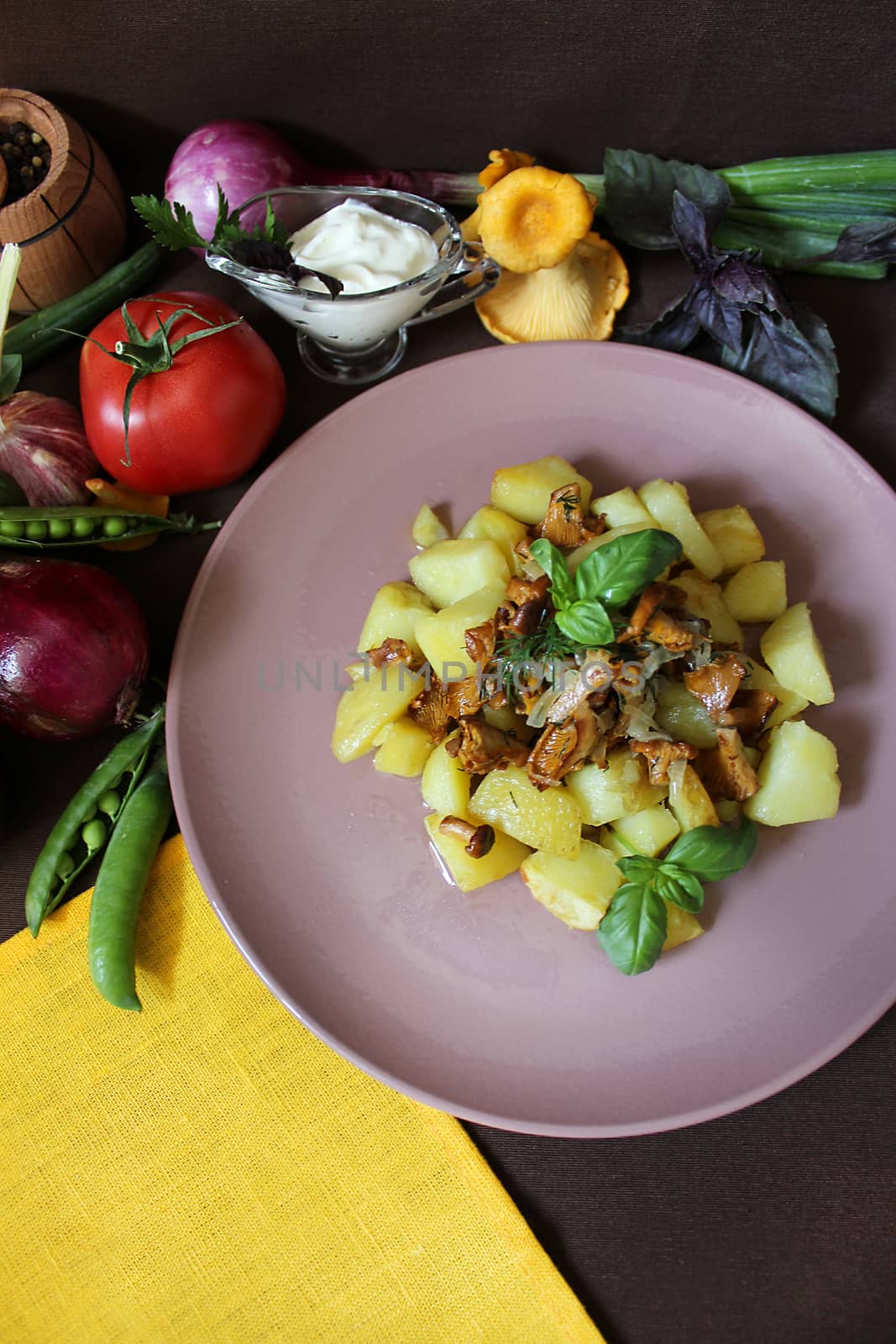 Fried potatoes with chanterelles and vegetables.Texture or background