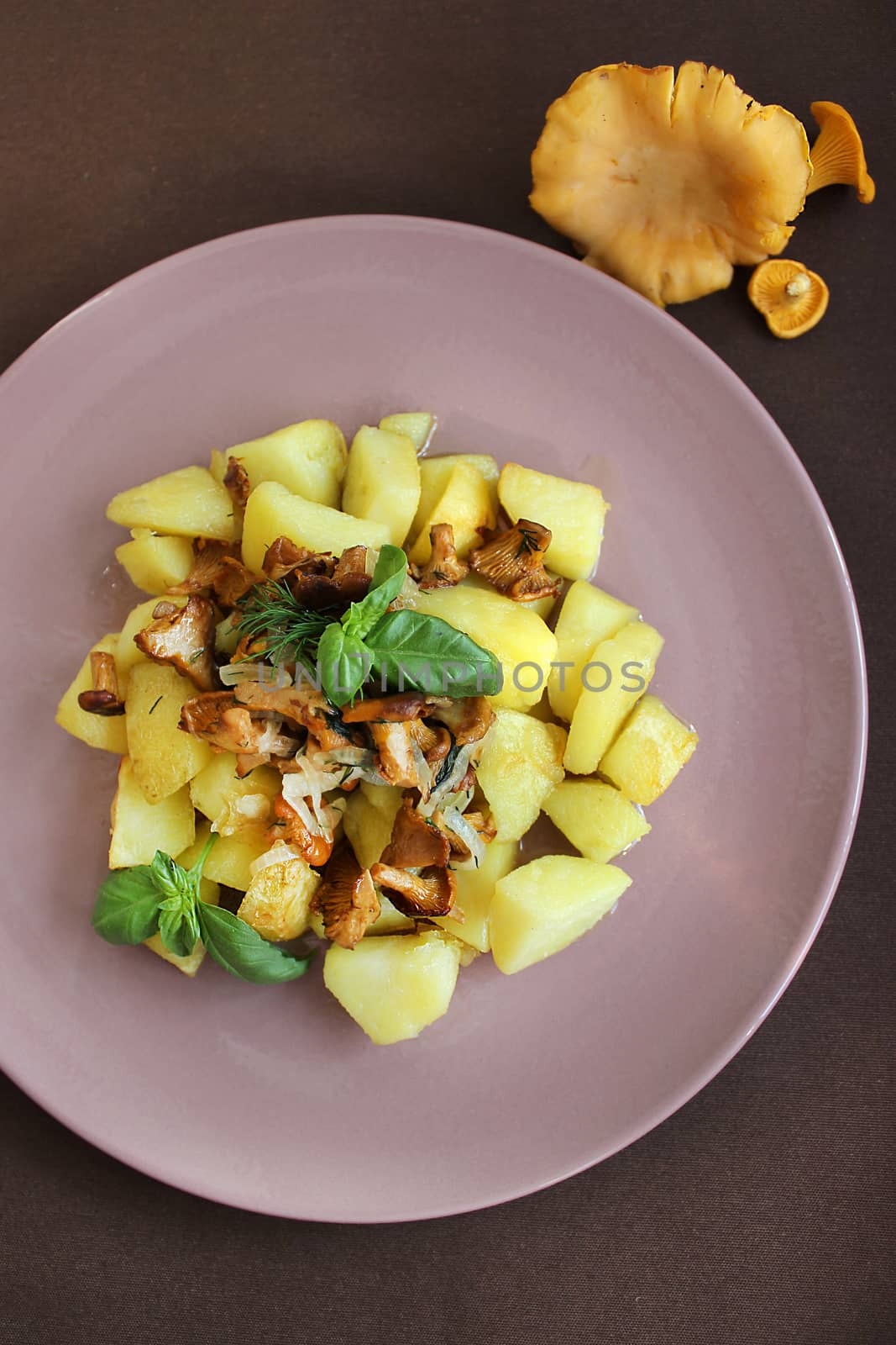Fried potatoes with chanterelle mushrooms.Texture or background