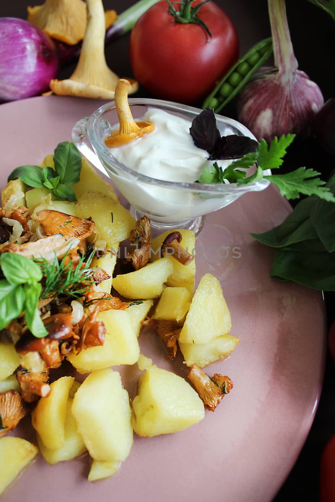 Fried chanterelles and potatoes with herbs and vegetables.Texture or background