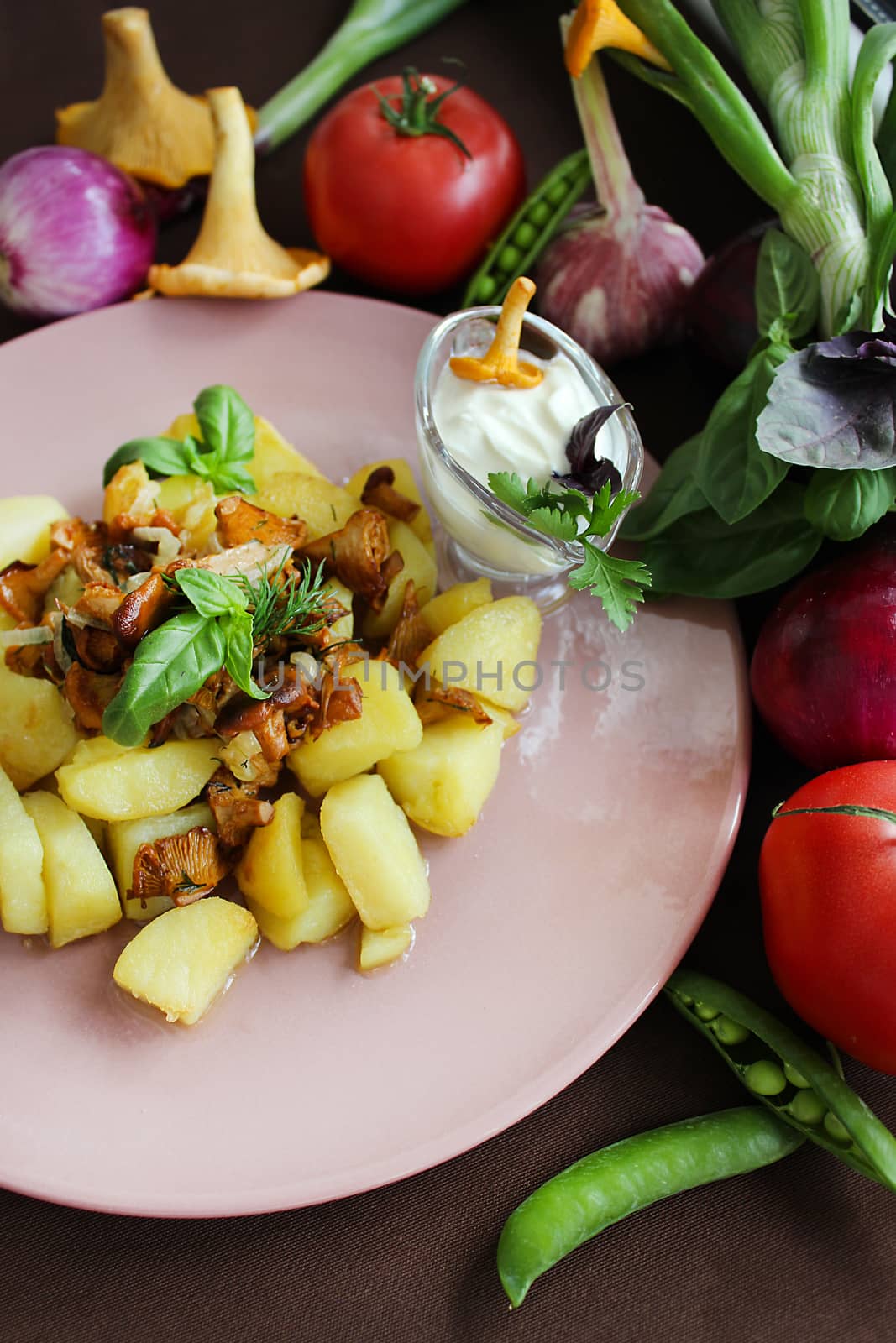 Rustic potatoes with fried chanterelles onions and vegetables.Texture or background