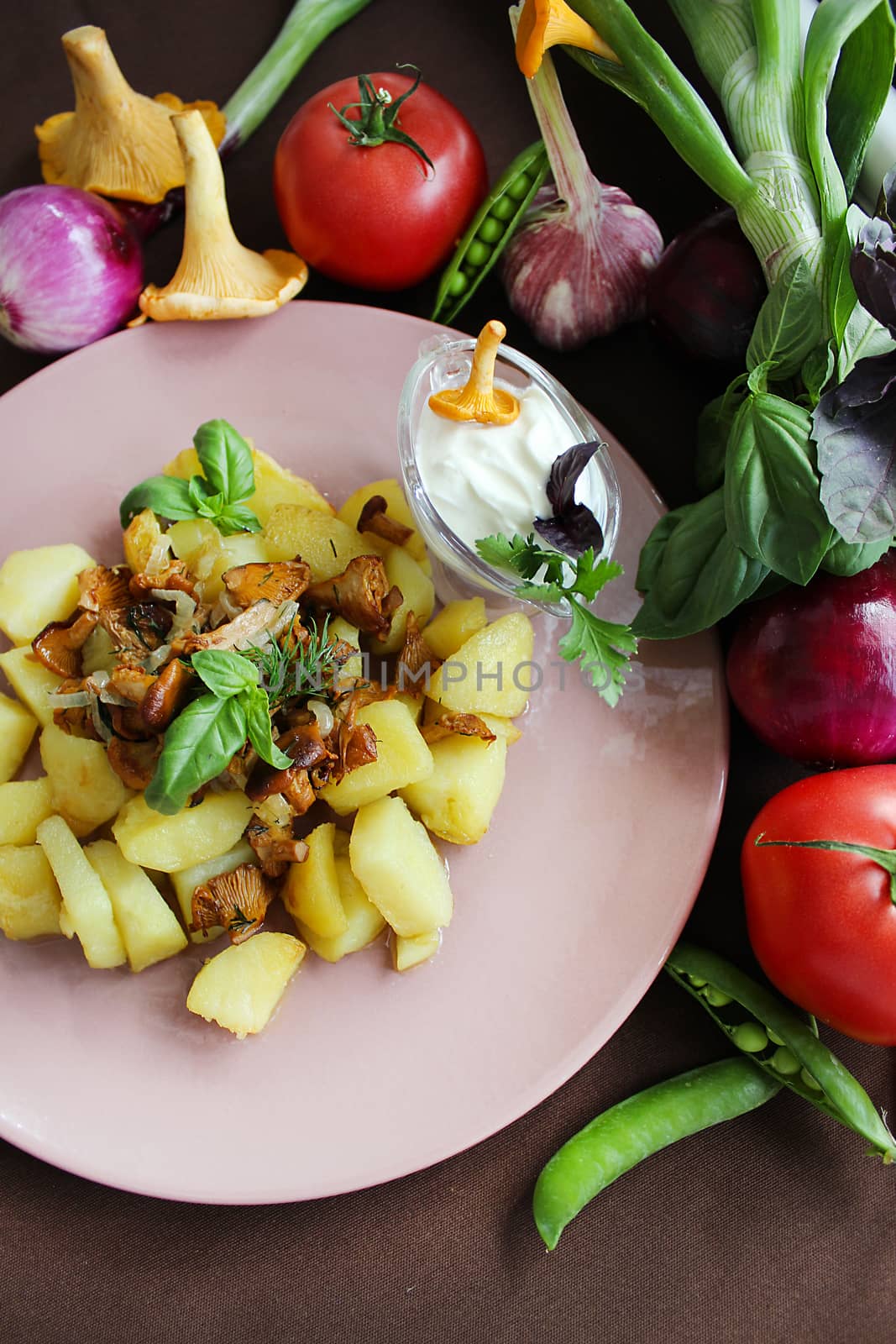 Fried potatoes with mushrooms with vegetables herbs and onions.Texture or background