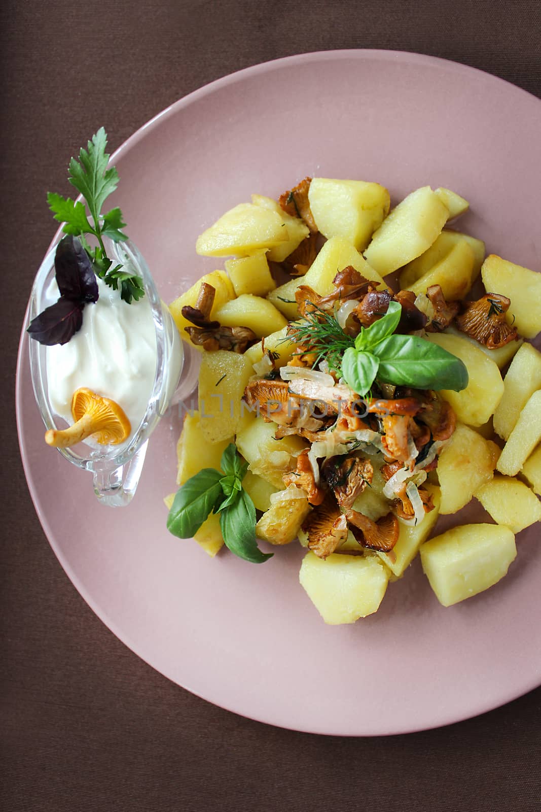On a plate fried chanterelles with onions and homemade potatoes.Texture or background