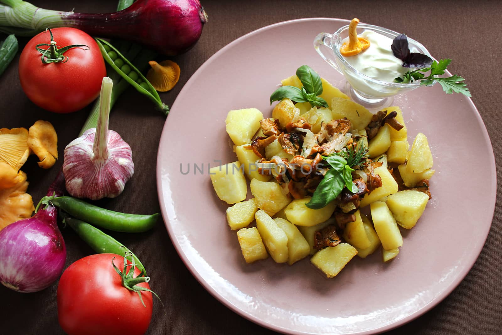 Home cooking potatoes with fried mushrooms with herbs and vegetables