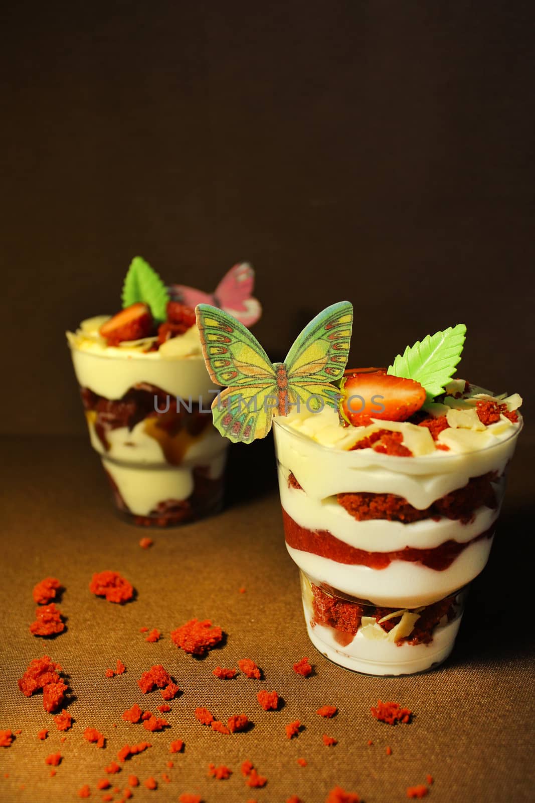 Strawberry ice cream with a cupcake and a slice of strawberry sprinkled with nuts.Texture or backgroun