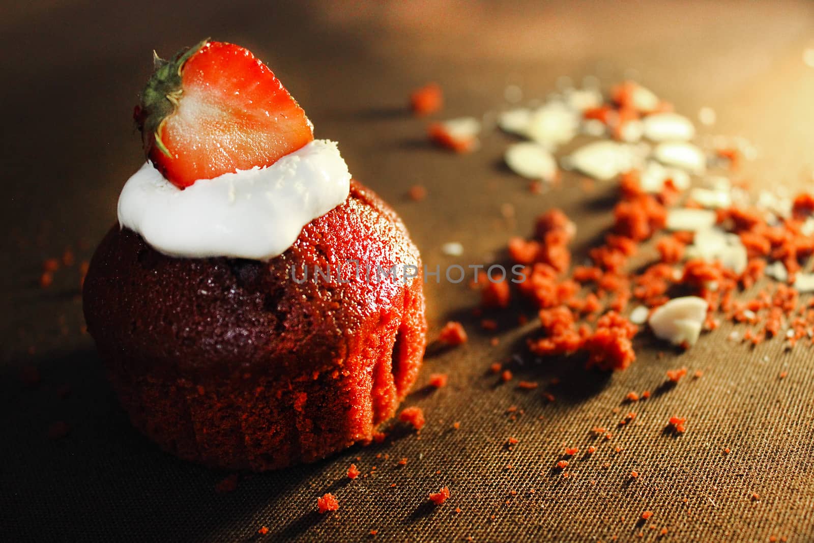 Strawberry cupcake is decorated with a strawberry slice .Texture or background