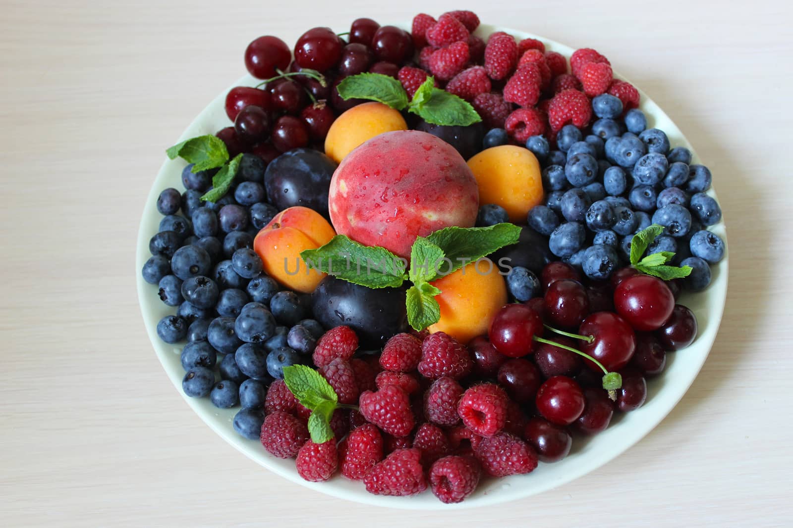 On the table on a white plate berry mix.Texture or background