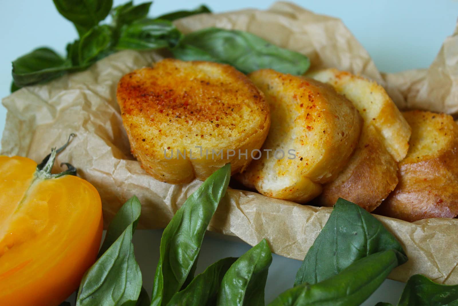 Toasted baguette slices with greens close up.Texture or background
