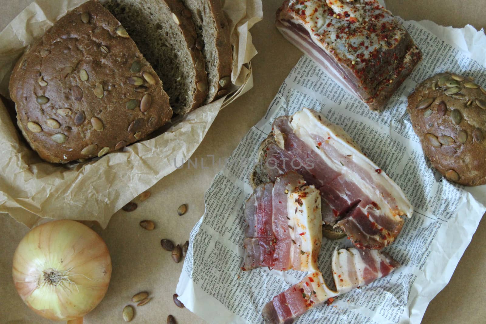 Sliced bread with bacon and onions are on the table.Texture or background