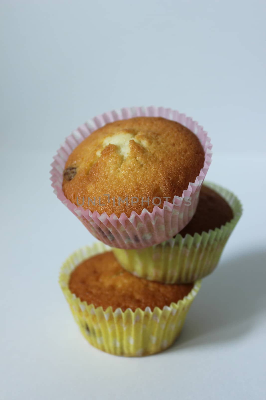 Delicious dessert three cupcakes for tea in a yellow wrapper .Texture or background
