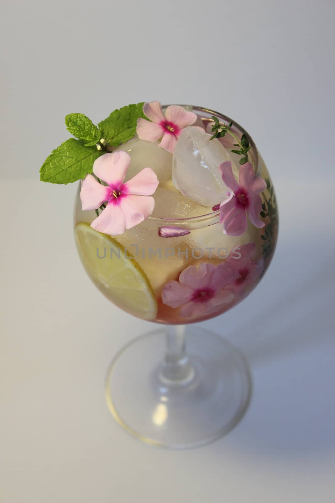 A glass of cold lemon juice with a leaf of green mint.Texture or background
