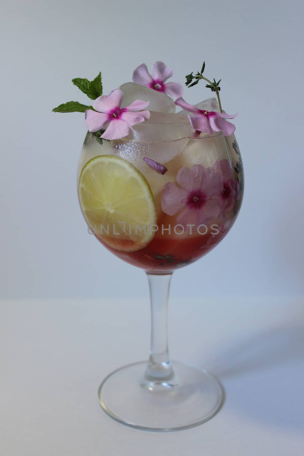 Fresh fruit lemon juice with ice cubes and a flower.Texture or background
