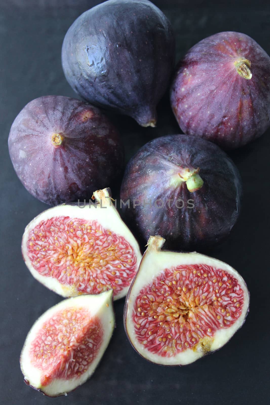 Fresh figs isolated on a dark background.Texture or background