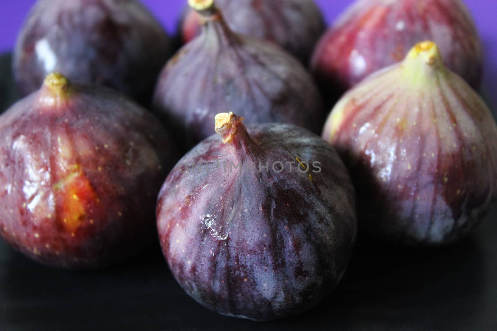 Large figs laid out in a row in close-up .Texture or background