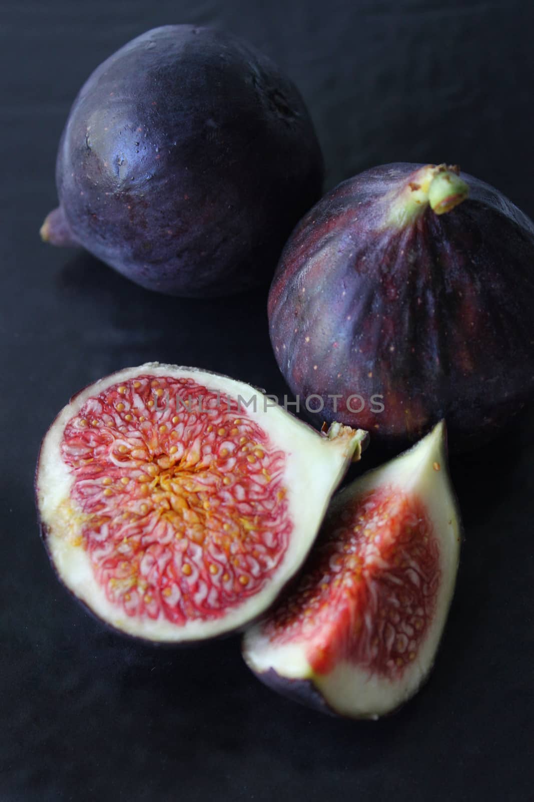 Juicy Fig slices on a dark background close-up.Texture or background