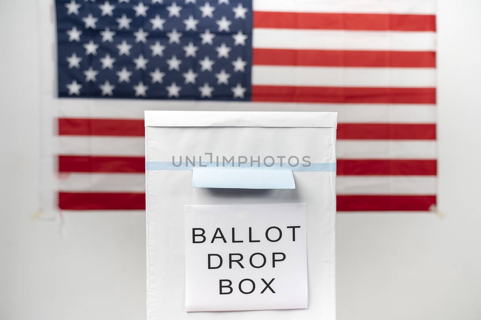 Concept of Mail in vote at US election -ballot box with us flag as background. by lakshmiprasad.maski@gmai.com