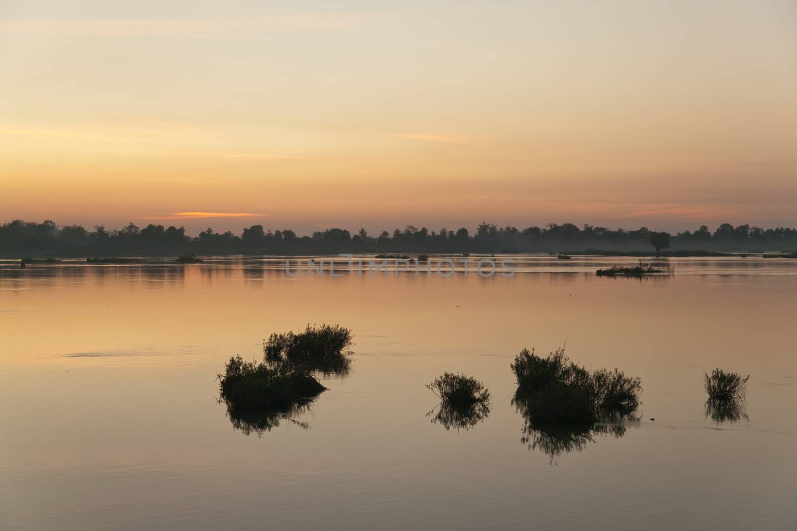 Muong Khong Laos 1/12/2012 Mekong river at dawn with golden sun rise over water by kgboxford