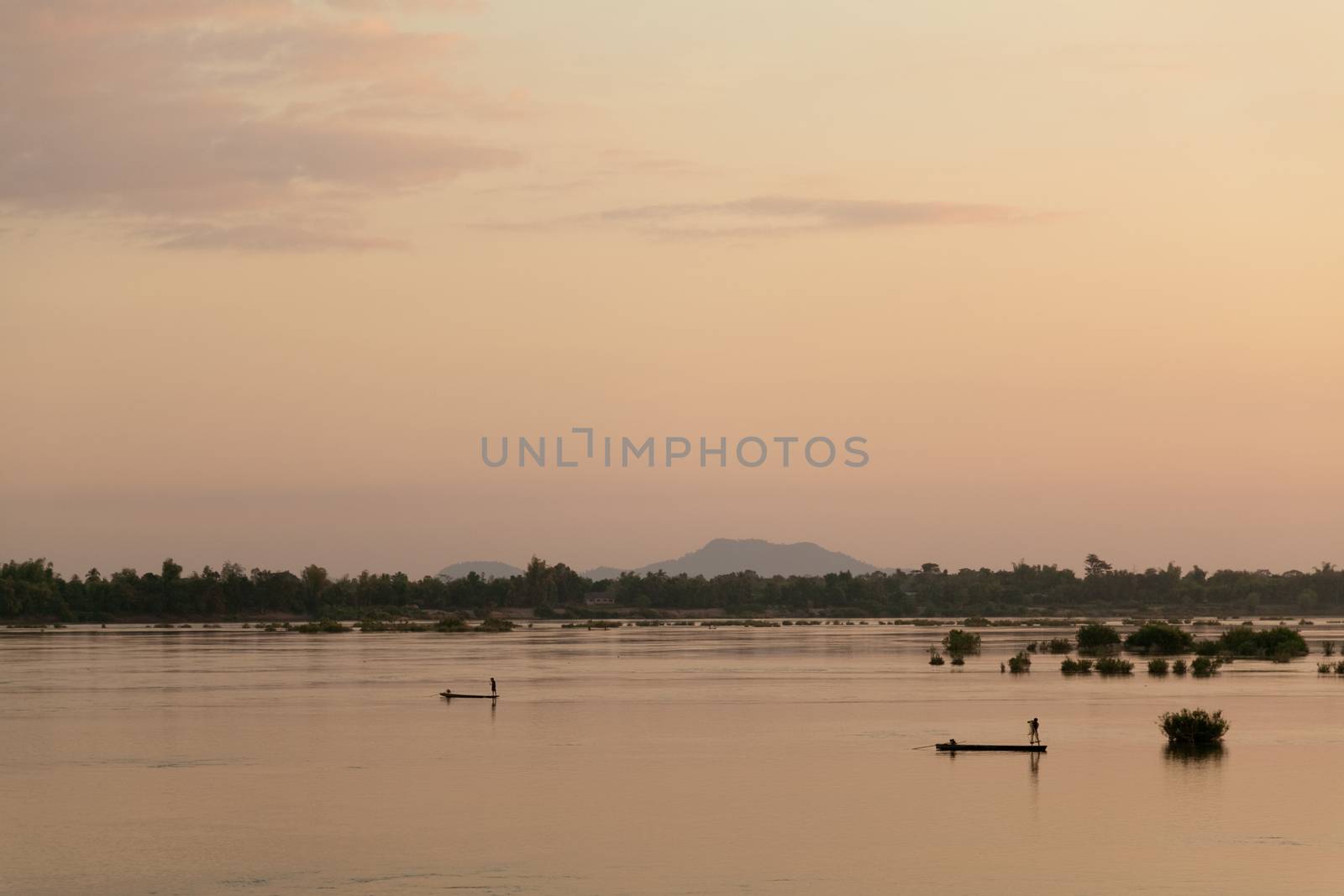 Muong Khong Laos 1/12/2012 Mekong river at dawn with golden sun and fishing boat by kgboxford