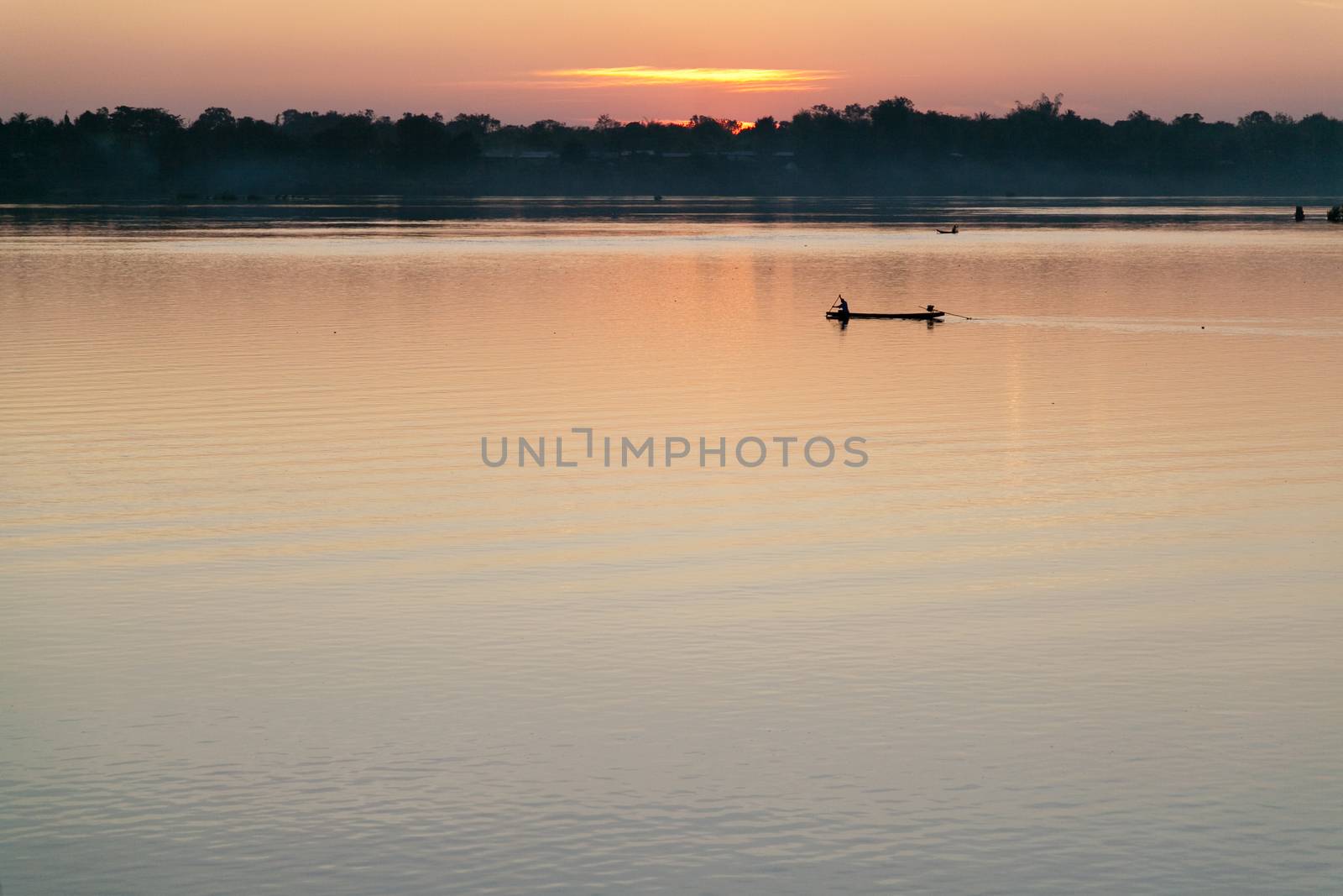 Muong Khong Laos 1/12/2012 Mekong river at dawn with golden sun and traditional fishing boats with nets . High quality photo