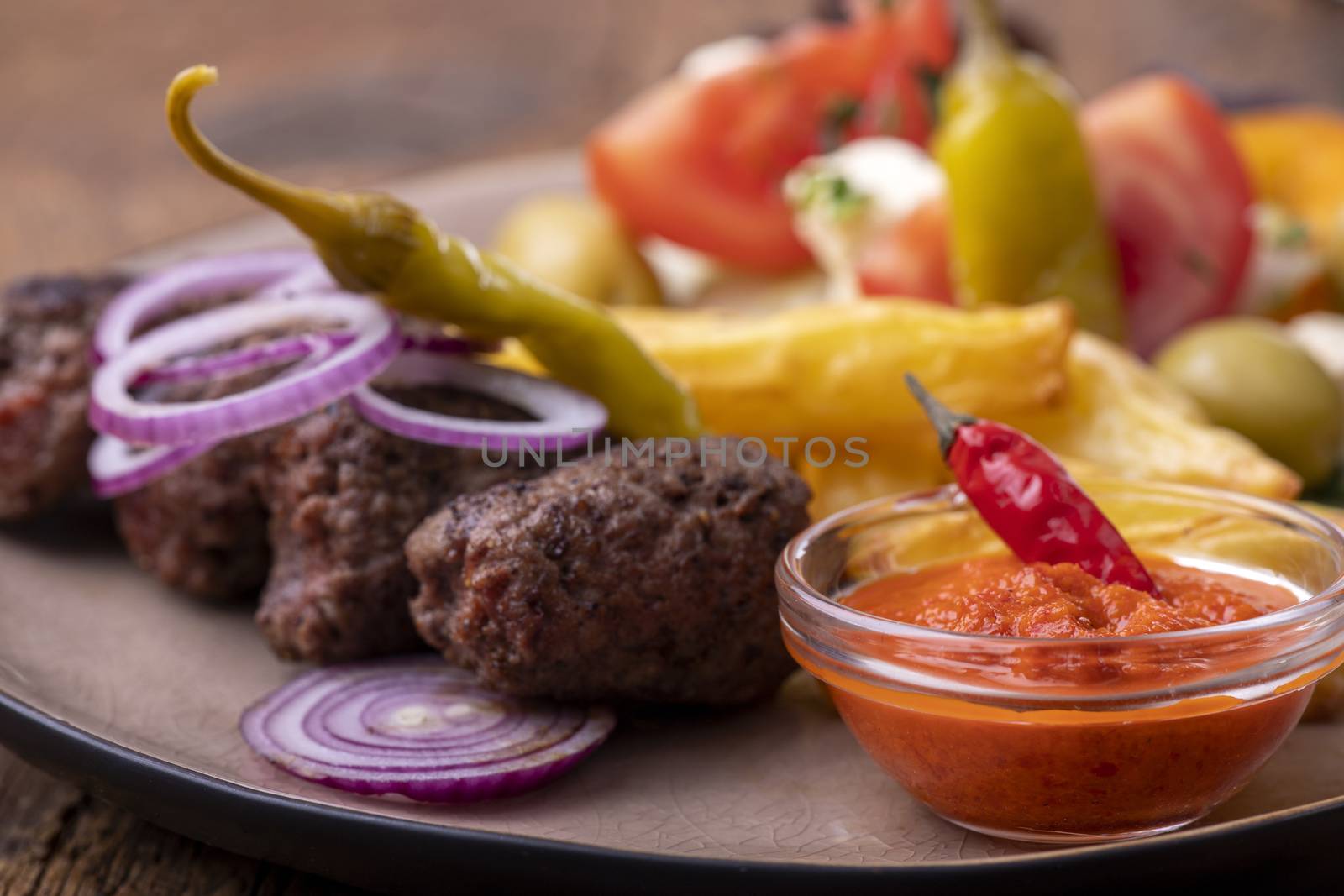 cevapcici on a plate with french fries