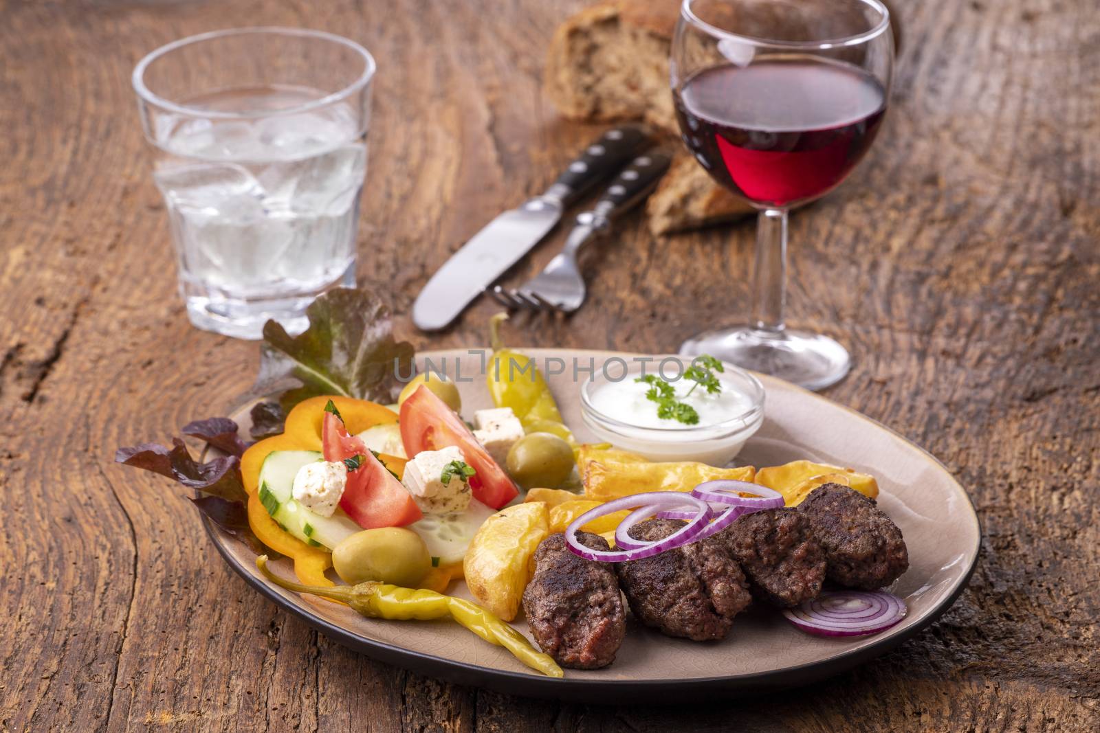 cevapcici on a plate with french fries