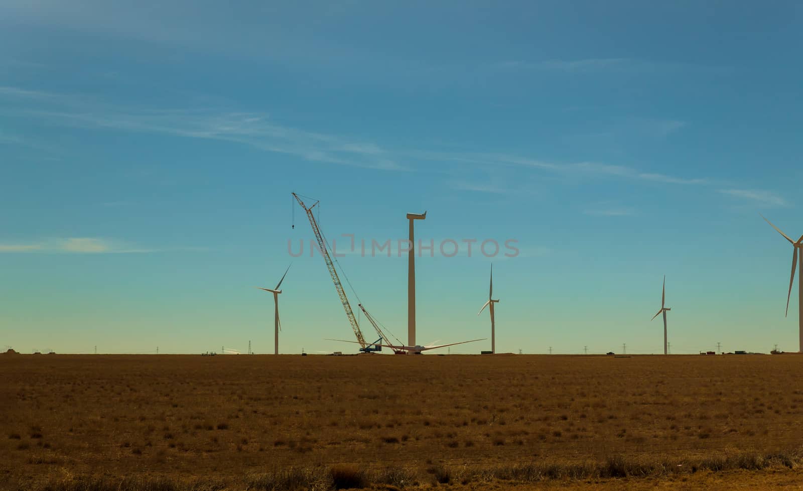 Electric wind turbine windmill installation wind turbine with blue sky background.