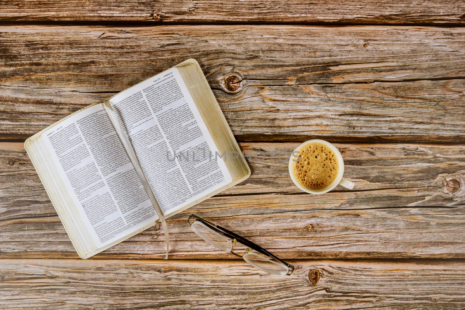 Los Angeles CA US 16 MAY 2020: Open Holy Bible morning readings on a table top with coffee cup and eyeglasses