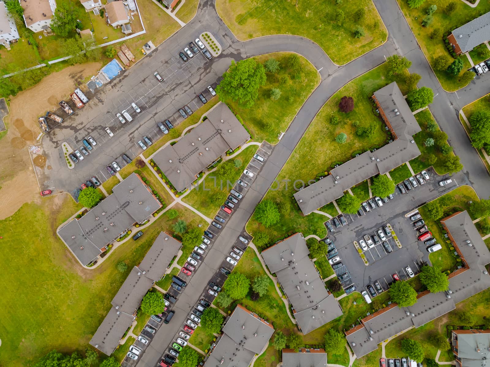 Overhead aerial view of the suburban area apartment district with cars parking lot stay home concept of self isolation during in the Covid19 coronavirus pandemic