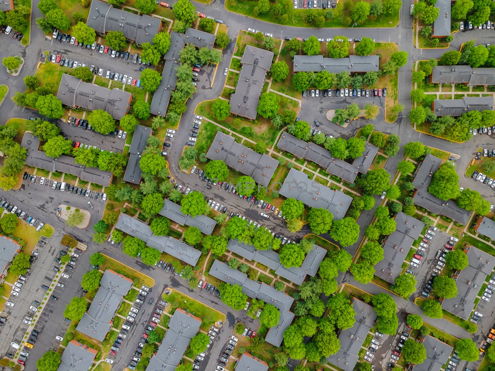 Cars parking in asphalt busy parking lot with stay home during the Covid 19 coronavirus pandemic aerial view of residential district with apartment