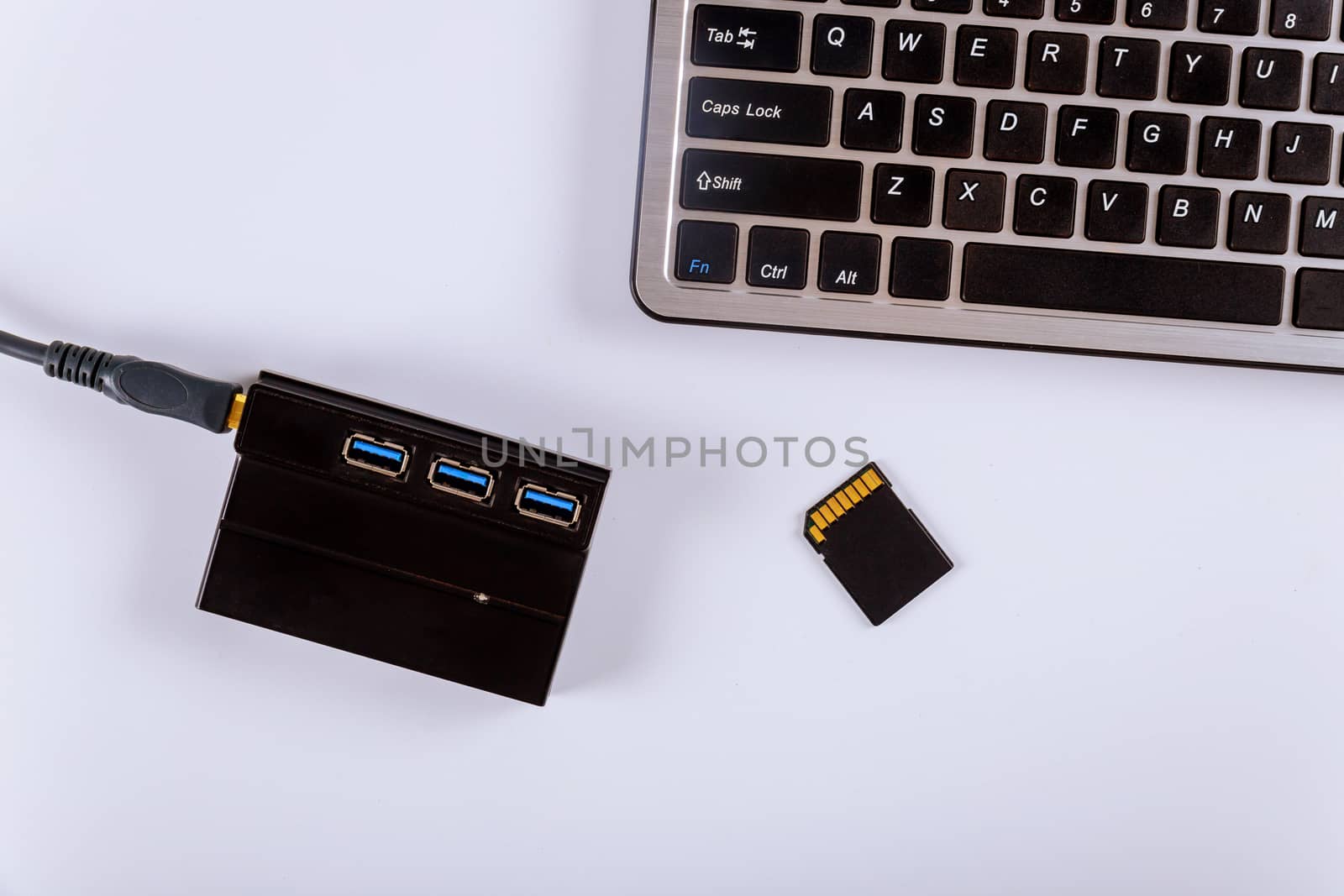 Workplace photographer copying photos from memory SD cards to laptop computer