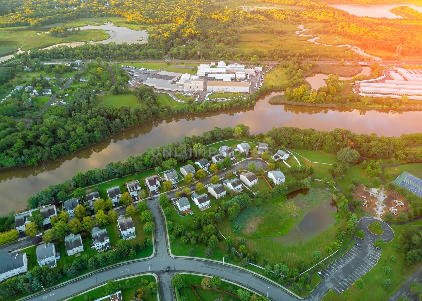 Wide panorama, aerial view with tall buildings, residential quarters and green streets in the beautiful sunrise