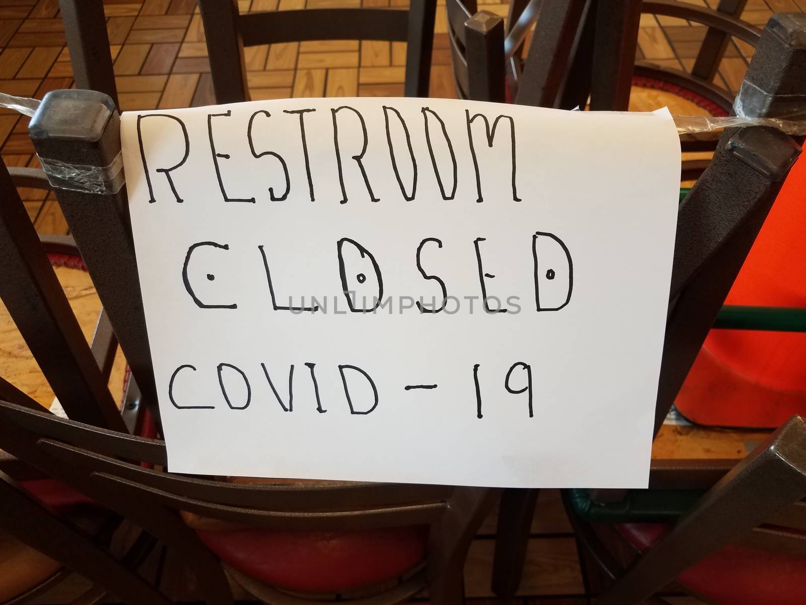 restroom closed covid 19 paper sign on chairs by stockphotofan1