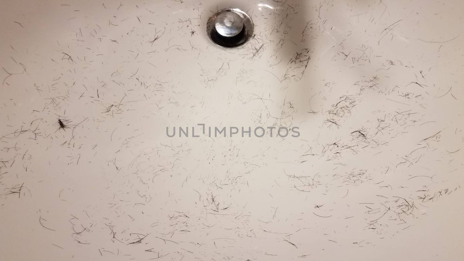 cut brown hair in white bathroom sink by stockphotofan1