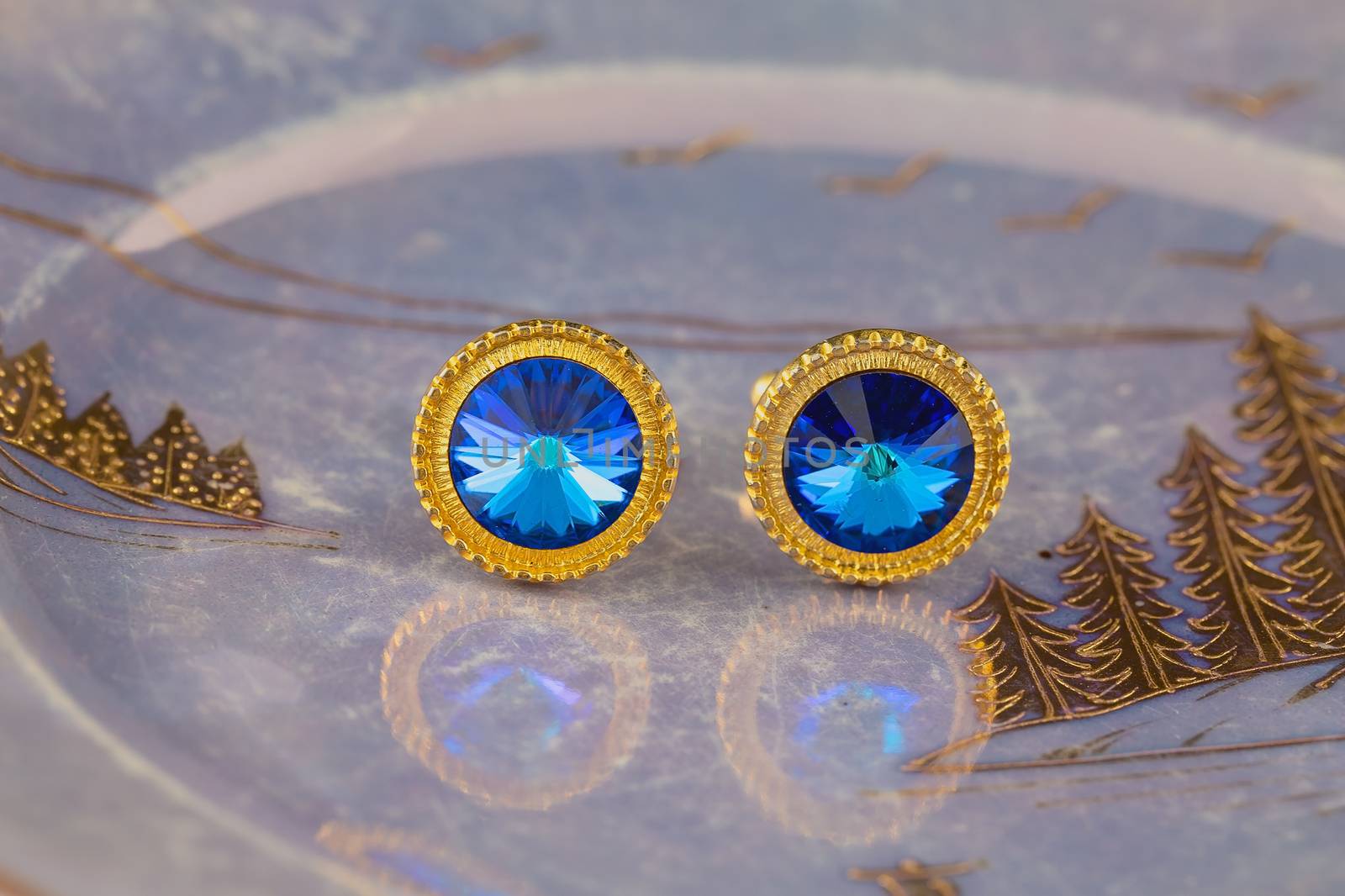 Vintage large gold blue stone cuff links on a lustrous plate