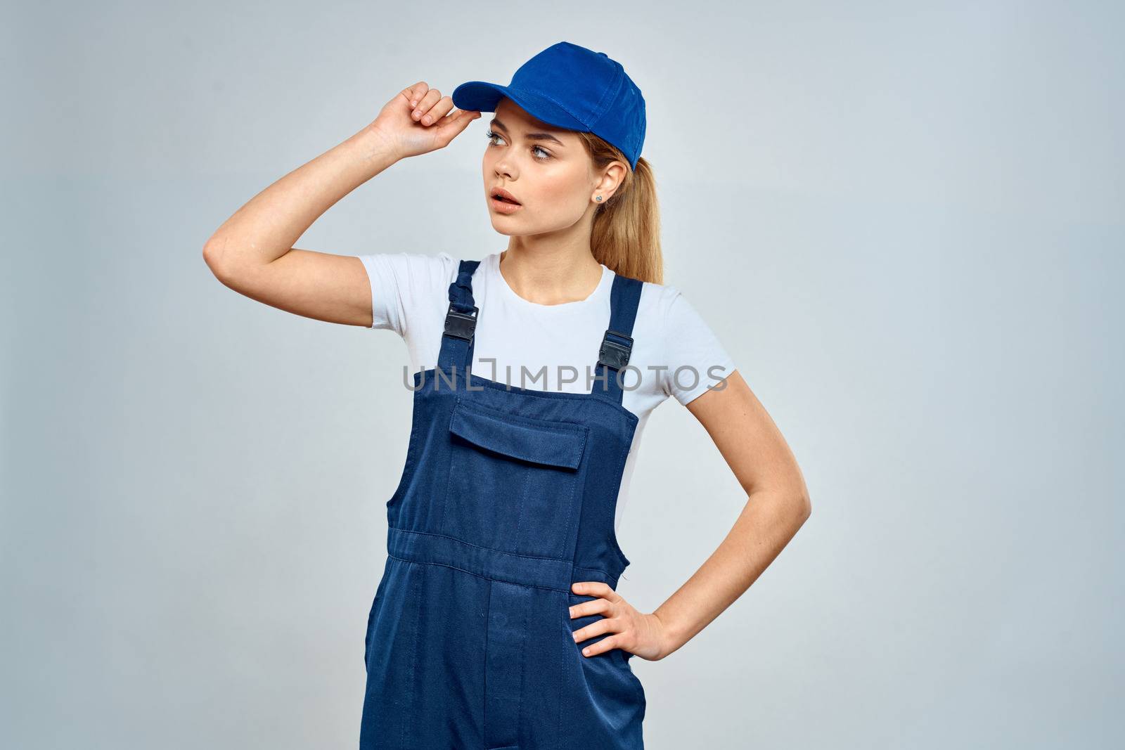 Woman in working uniform blue cap service lifestyle service by SHOTPRIME