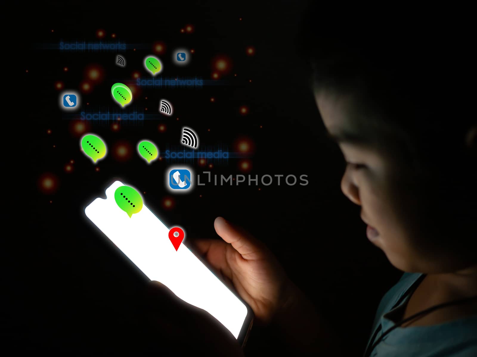 Boy holding The phone screen is blank And has a social media icon Put on a dark background. internet and communication concept.