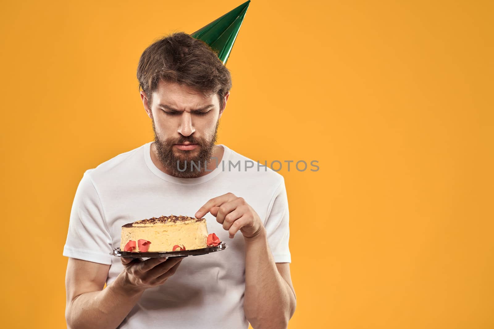 A bearded man with a cake and in a cap celebrating his birthday by SHOTPRIME