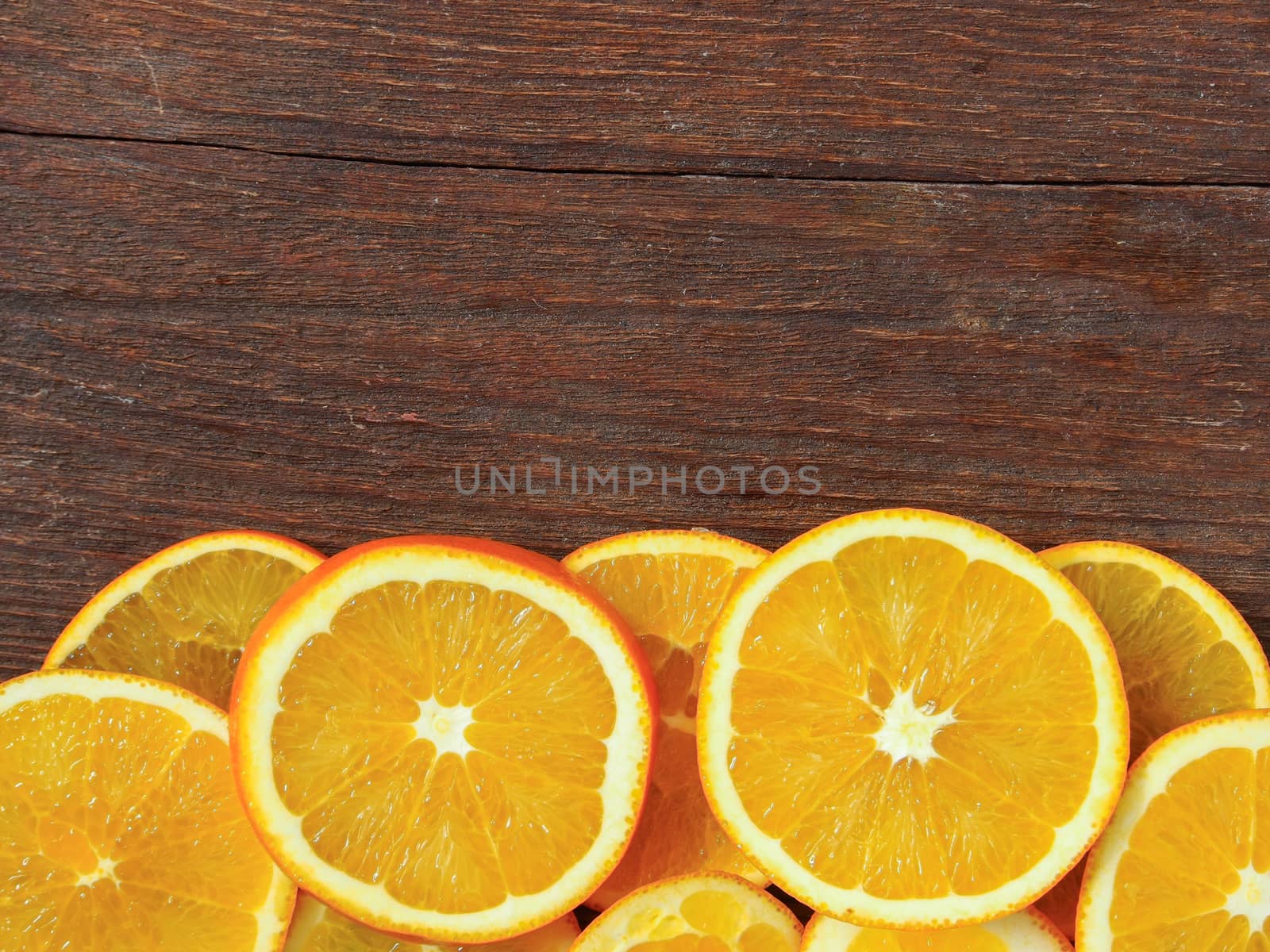 orange halves placed on a wooden table