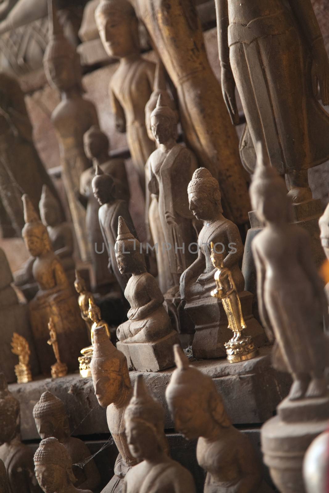 Ou Pak Caves Laos with small and miniature Buddha statues in many different pose by kgboxford